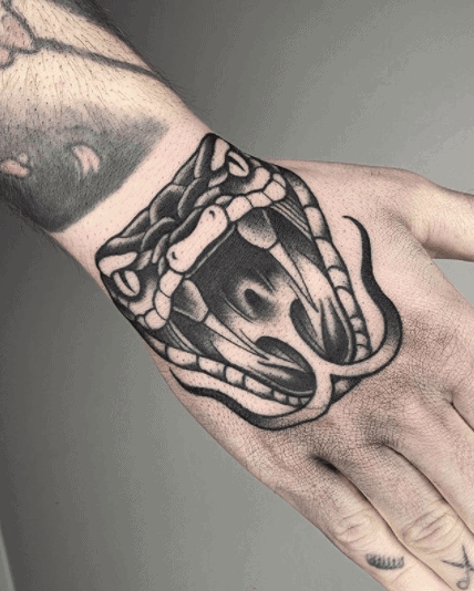 Snake head tattoo on the hand for men