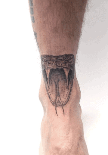 Snake head tattoo on the leg for men