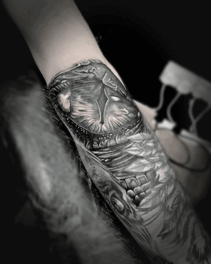 Snake eye tattoo on forearm for women