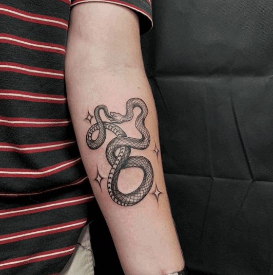 Ouroboros tattoo on the forearm for men