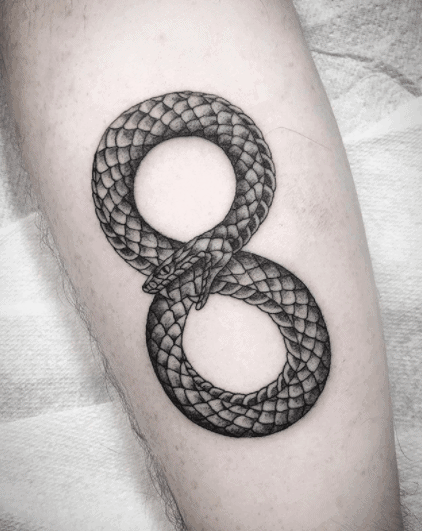 Ouroboros tattoo on the shin for men