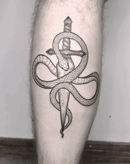 Snake and dagger tattoo on the shin for men