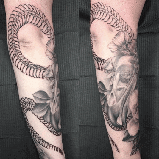 Snake skeleton tattoo on forearm for women