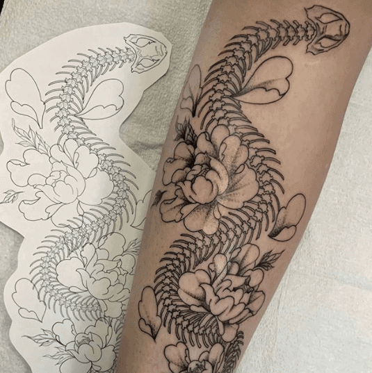 Snake skeleton tattoo on forearm for women