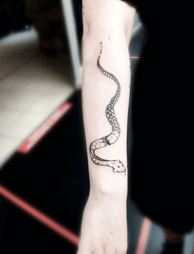 Snake skeleton tattoo on forearm for women