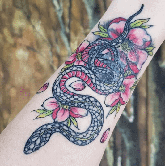 Crowley snake tattoo on forearm for women