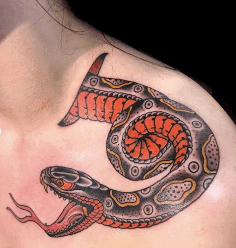 Tattoo of a colored snake on the shoulder for men