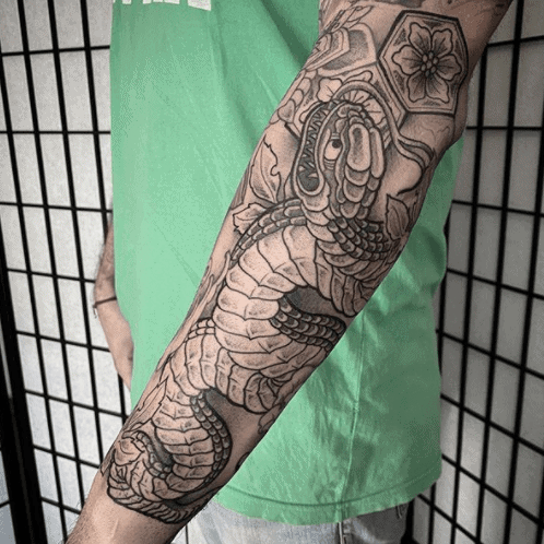 Snake tattoo on forearm for men