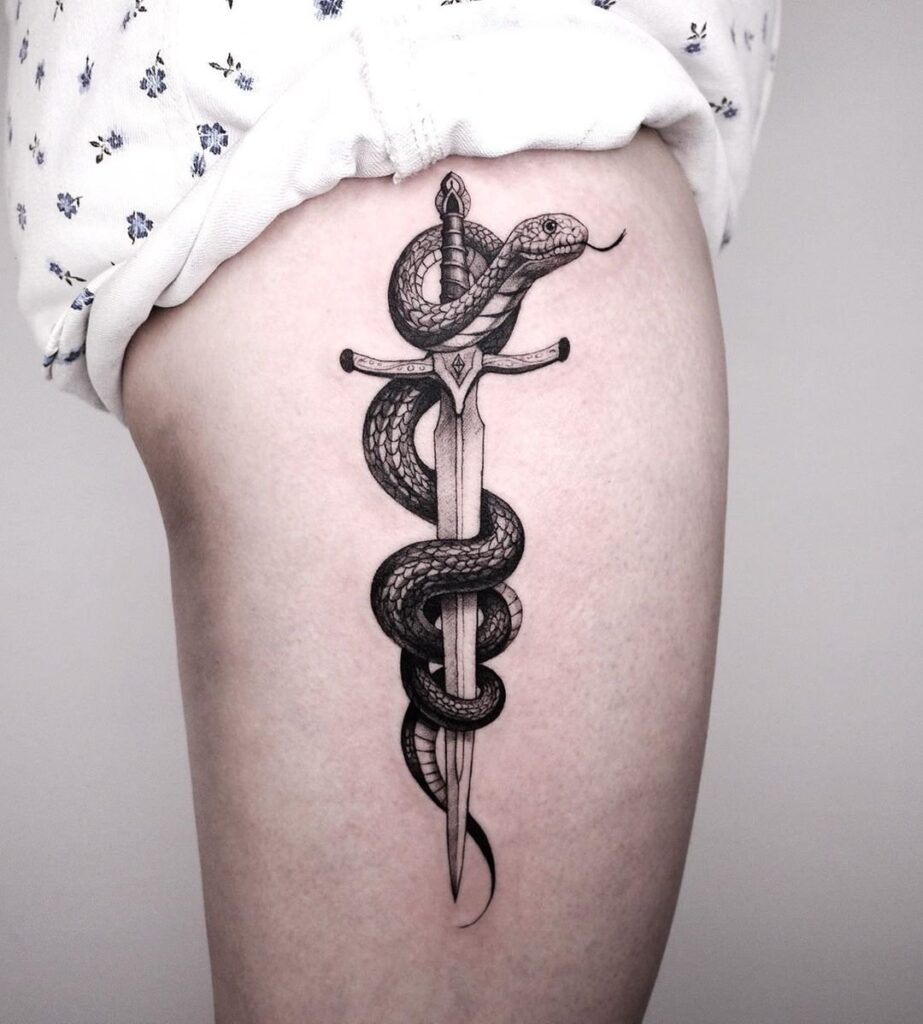 Snake tattoo on the thigh for women