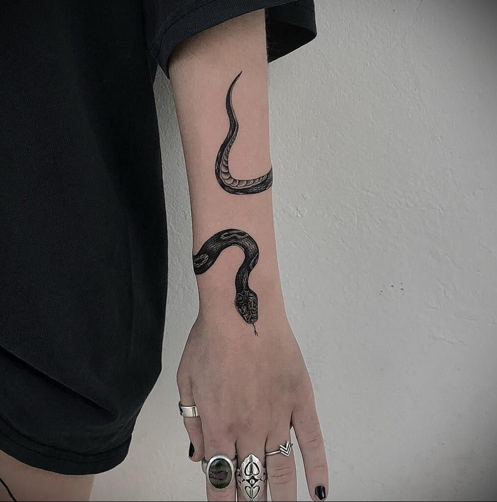 Snake tattoo on the forearm for women