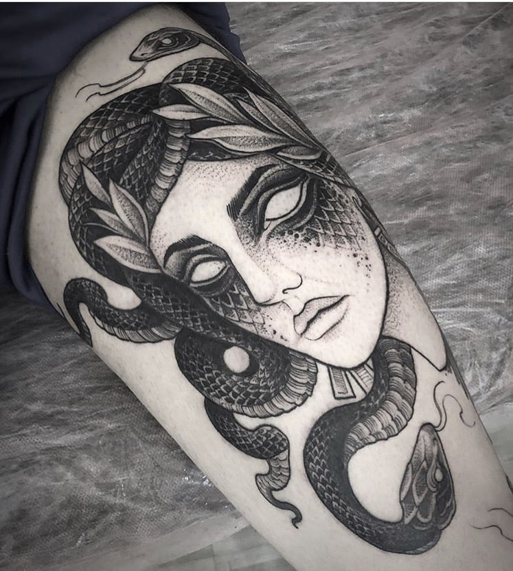 Snake tattoo on the thigh for men