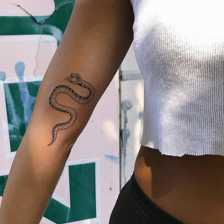 Snake tattoo on the forearm for women