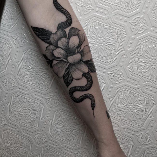 Snake tattoo on the forearm for women