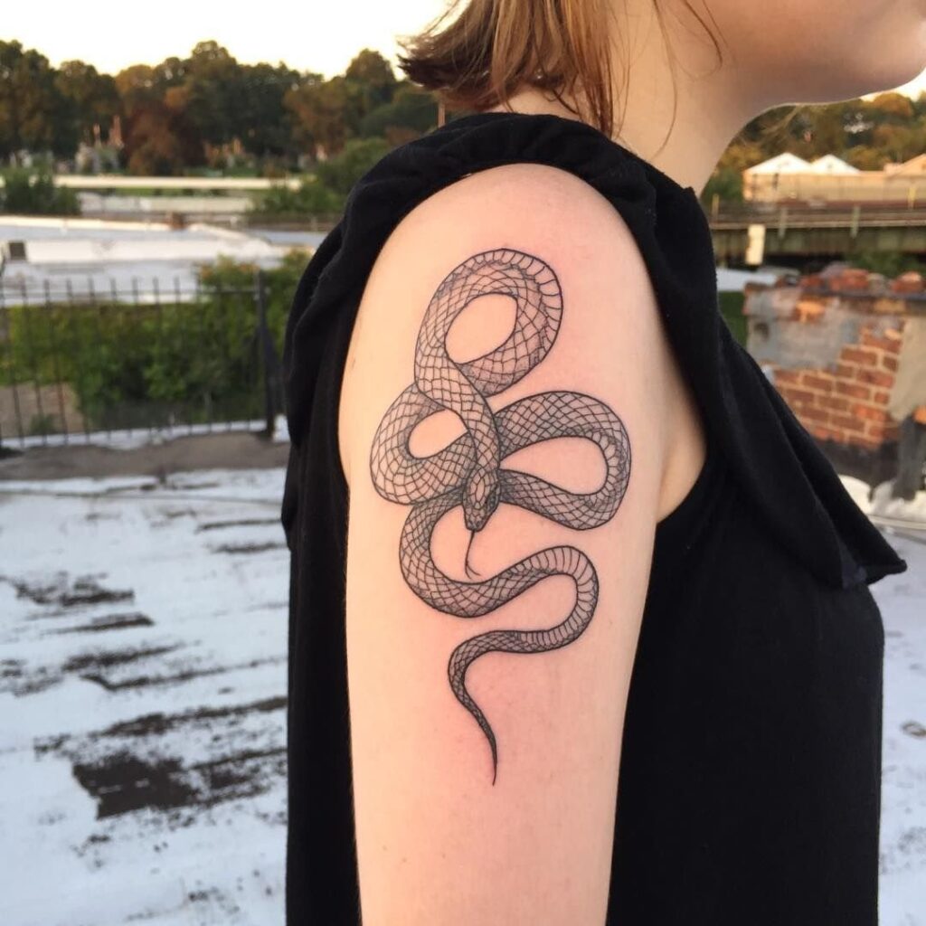 Snake tattoo on the shoulder for women