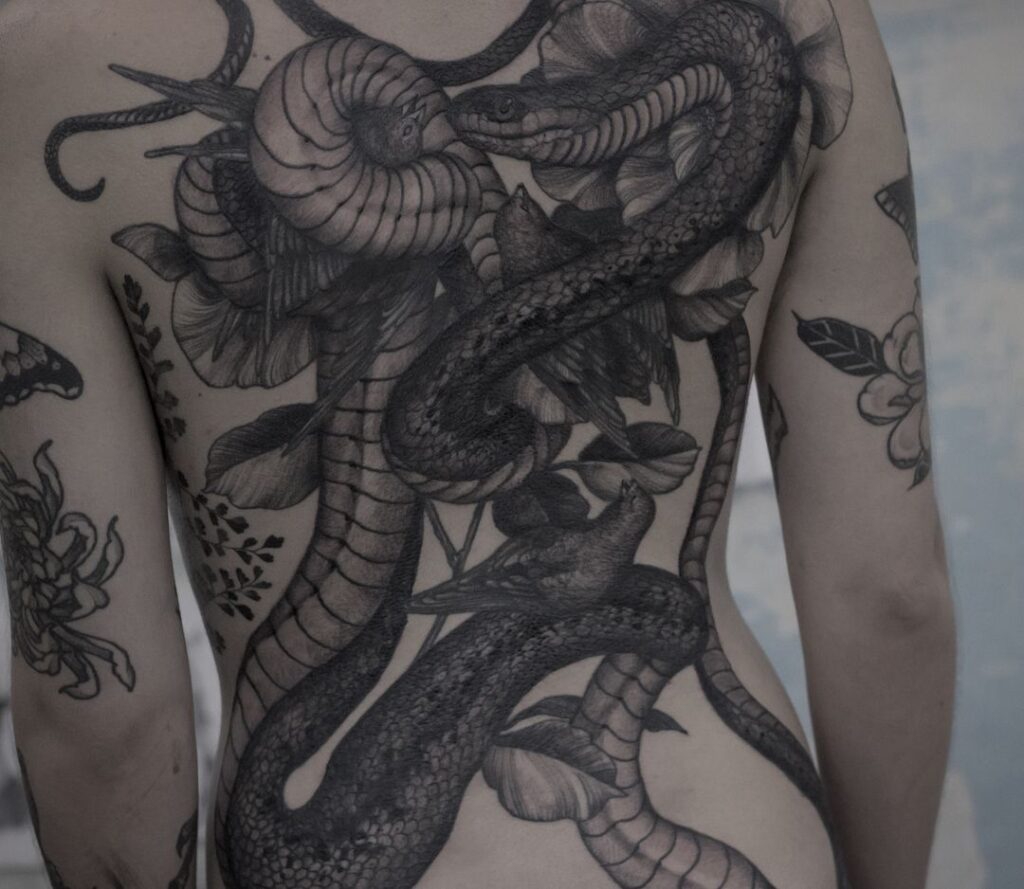 Snake tattoo on the back for women