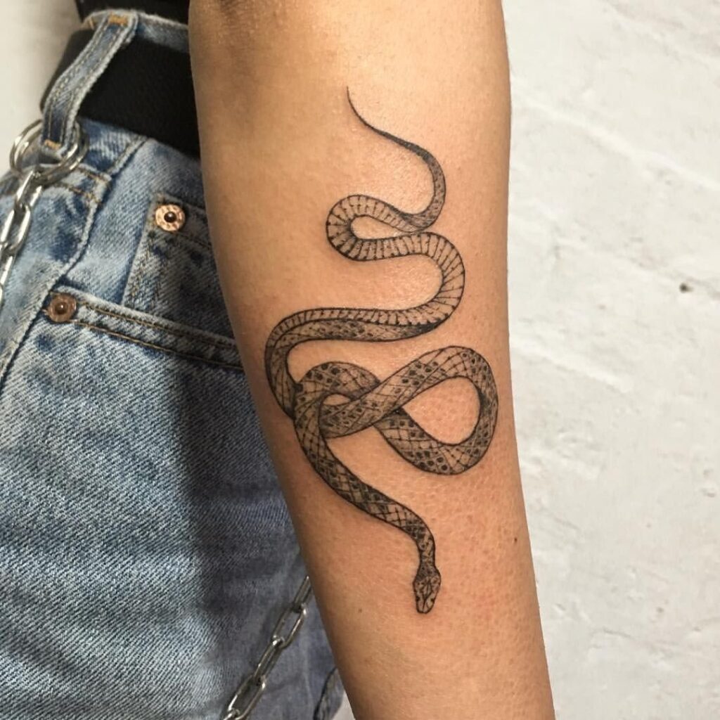 Snake tattoo on the forearm for women