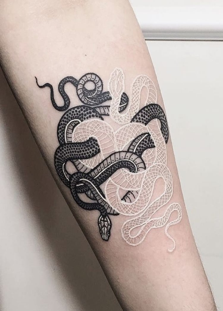 Snake tattoo on the forearm for women