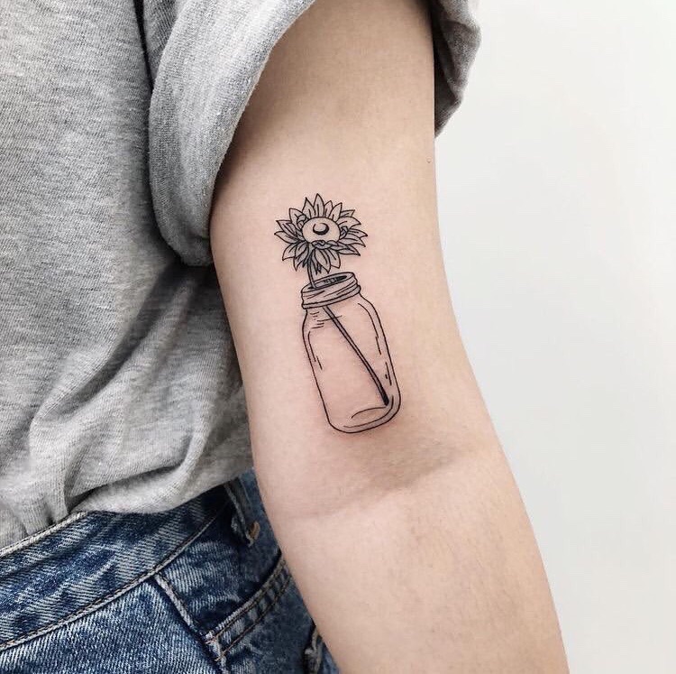 Sunflower tattoo in a jar on the shoulder for women