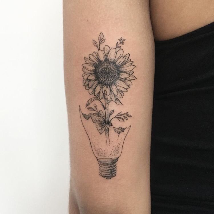 Large sunflower tattoo in a bulb on the shoulder for women