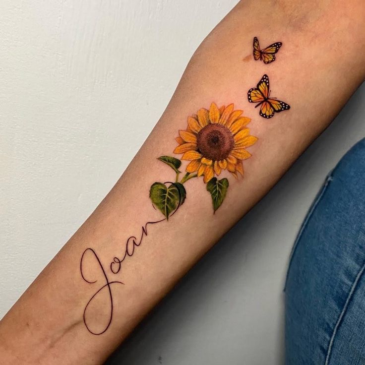 Colorful sunflower tattoo with an inscription on the forearm for women