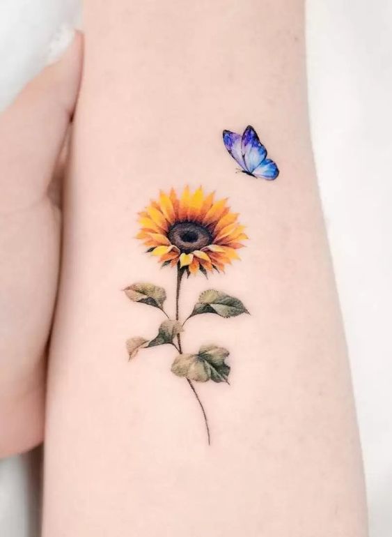 Sunflower tattoo with a butterfly on the shoulder for women