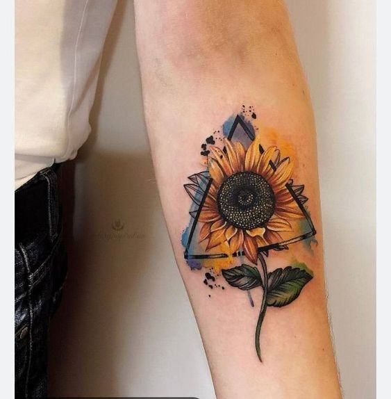 Colorful sunflower tattoo in a triangle on the forearm for men