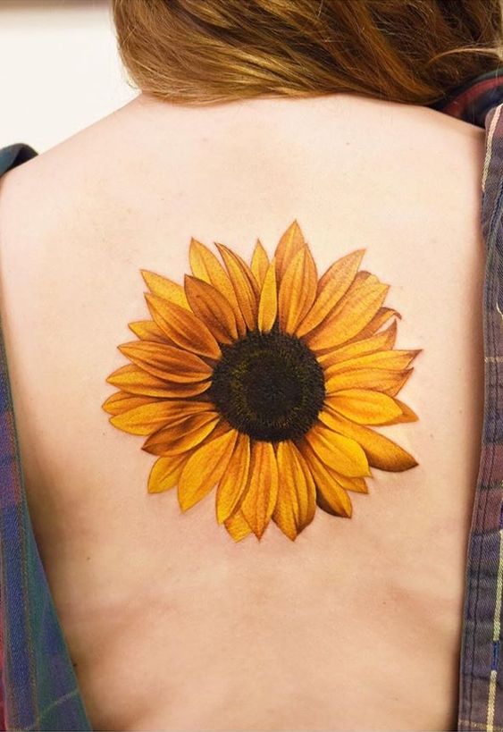 Color sunflower tattoo on the back for women