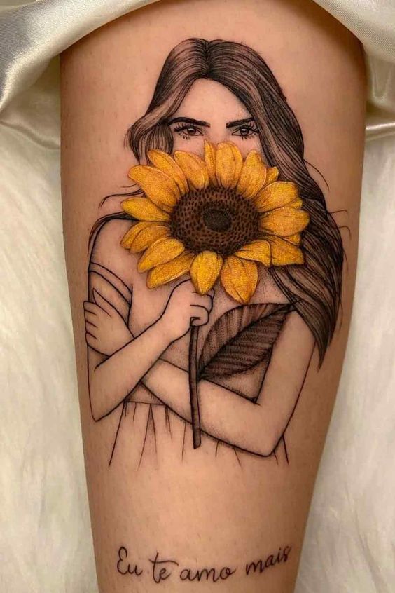 Large sunflower tattoo with an inscription for women