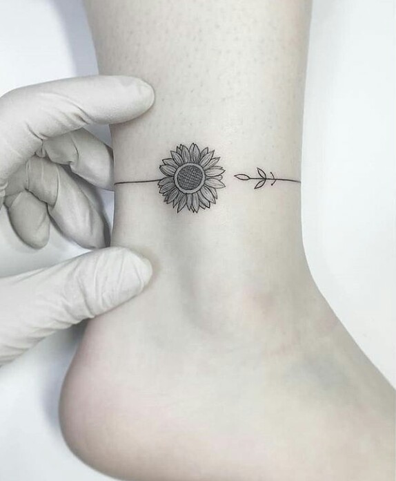 Sunflower tattoo on the leg for women