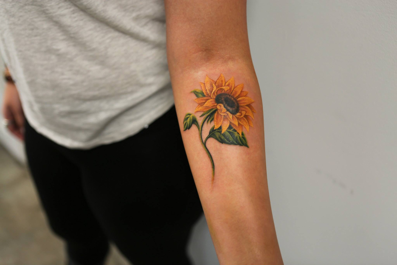 Colorful sunflower tattoo on the forearm for women