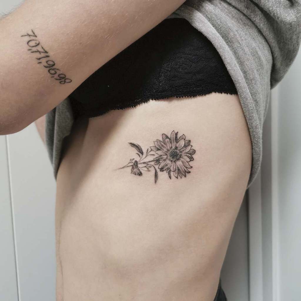 Sunflower tattoo on the side for women