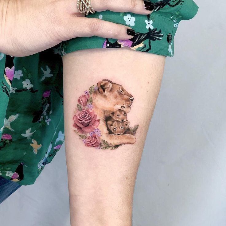 Tattoo of three lions on the shoulder for women