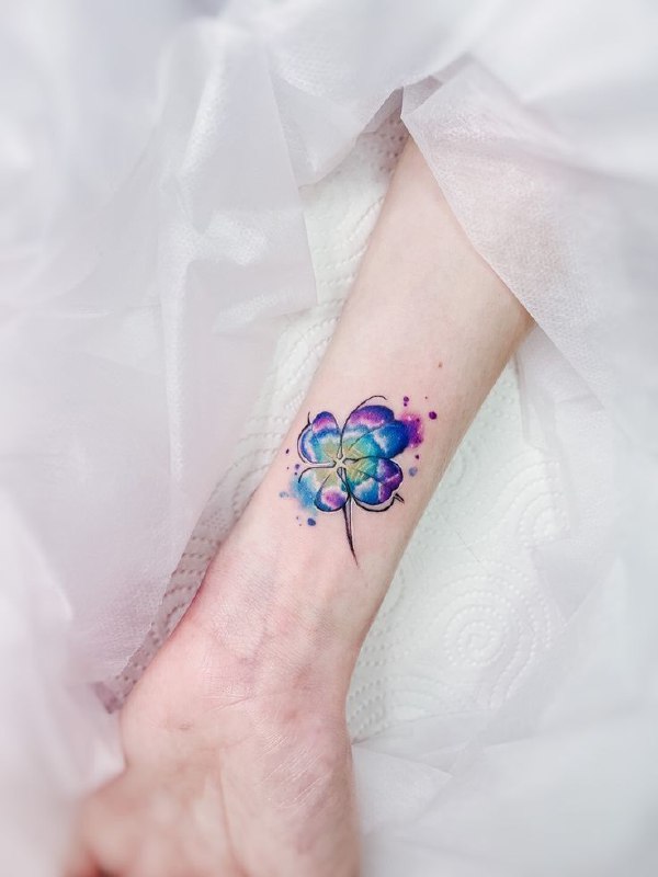 Colorful clover tattoo on the arm for women