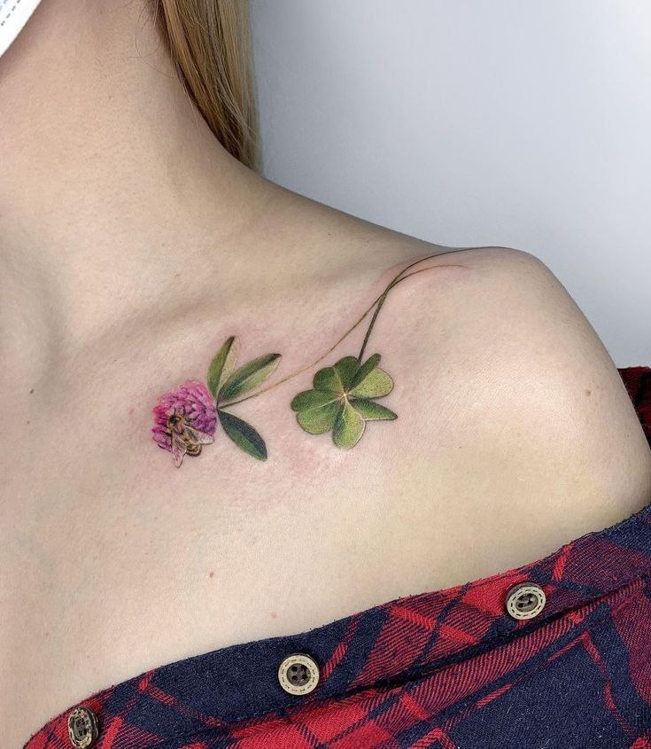 Colored clover tattoo on the collarbone for women