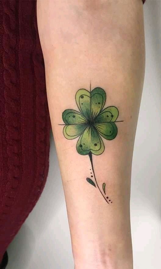 Colored clover tattoo on the forearm for women