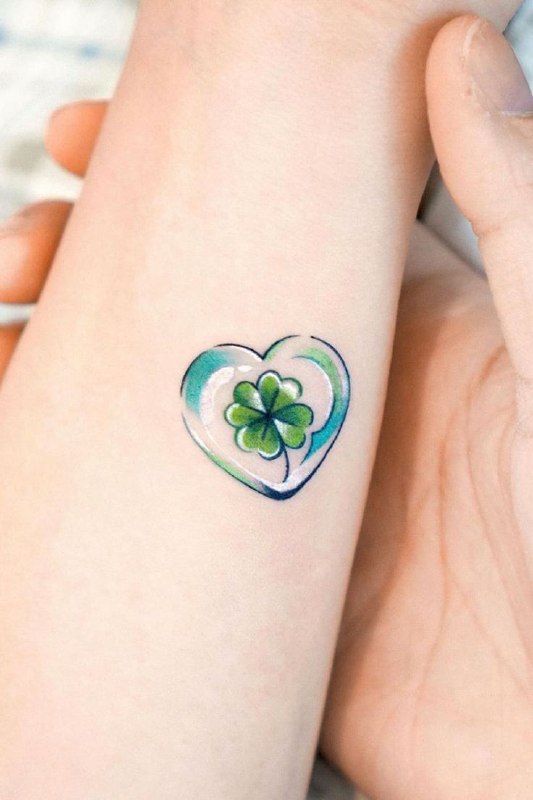 Colored clover tattoo on the forearm for men