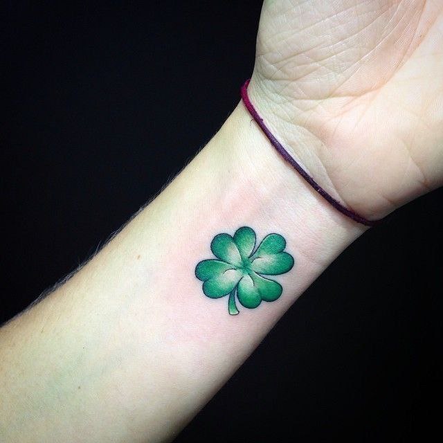 Colored clover tattoo on the arm for men