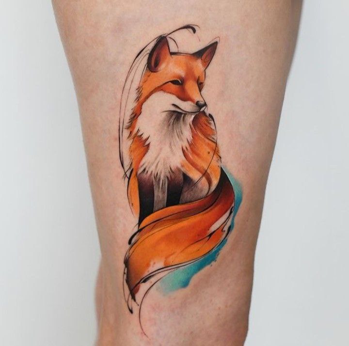 Tattoo of a colored fox on the leg for women