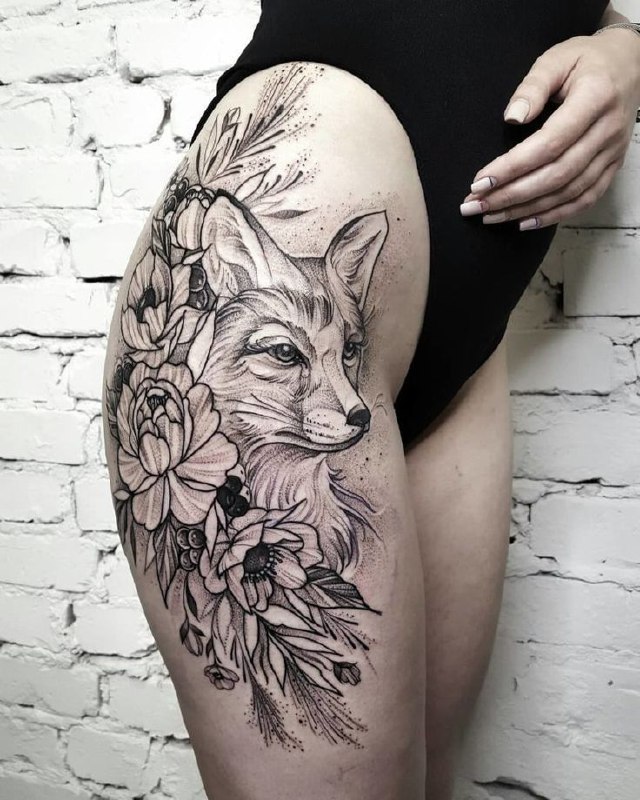 Tattoo of a fox with flowers on the hip for women