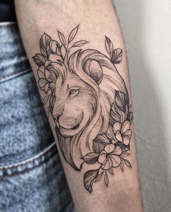 Tattoo of a lion with flowers on the forearm for women