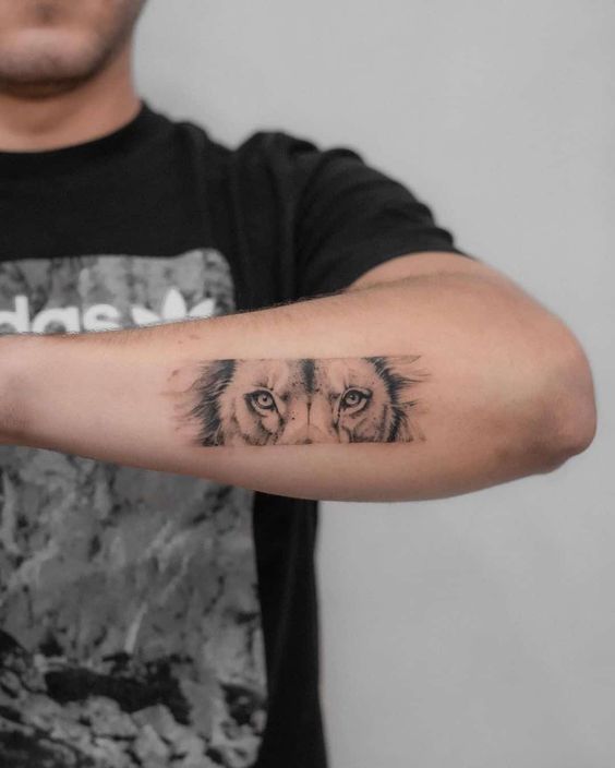 Tattoo of a lion on the forearm for men