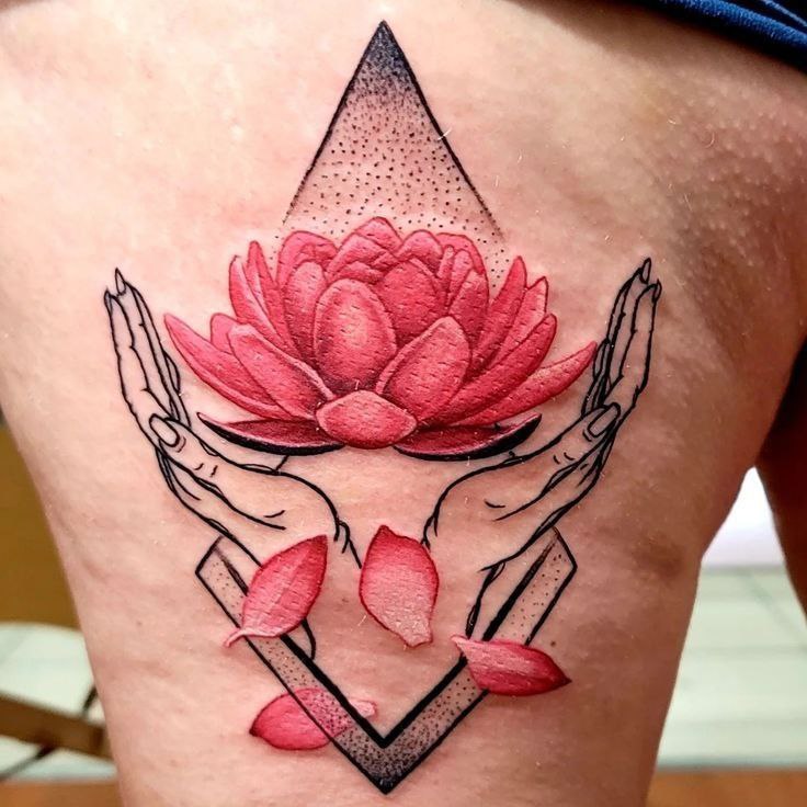 Colorful lotus and hand tattoo on the thigh for women