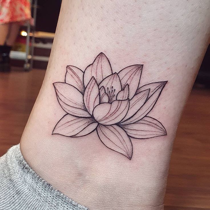 Lotus tattoo on the shin for women