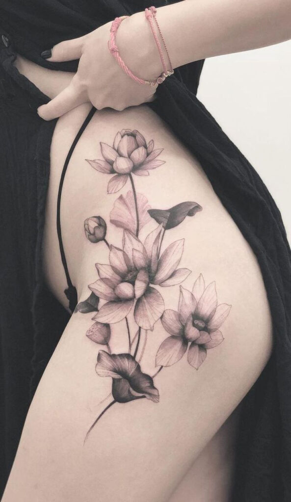 Large lotus tattoo on the thigh for women