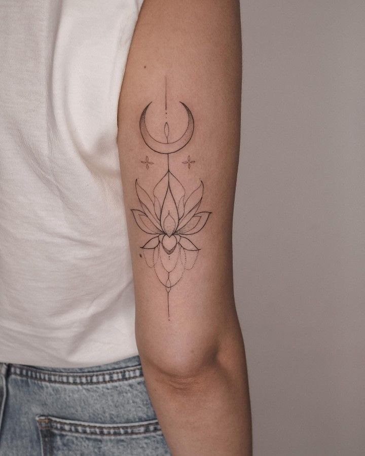 Lotus and month tattoo on the shoulder for women