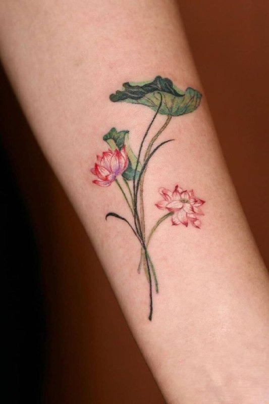 Colored lotus tattoo on the forearm for women