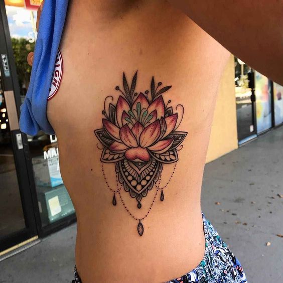 Colored lotus tattoo on the side for women