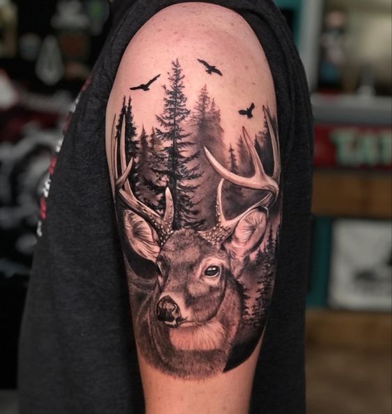 Tattoo of a deer on the shoulder for men