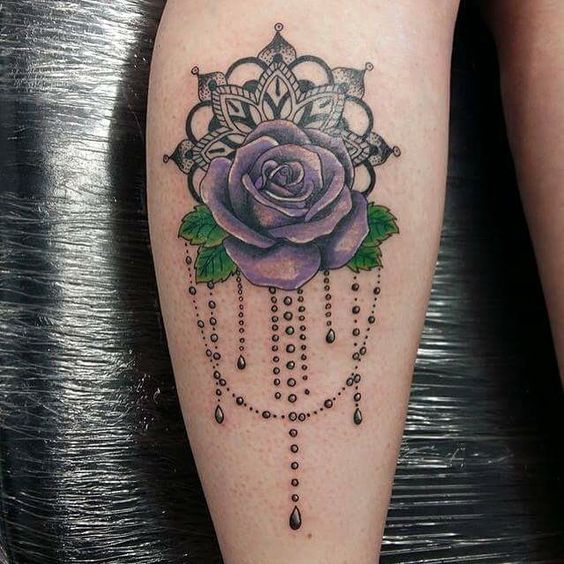 Color rose tattoo on the calf for women