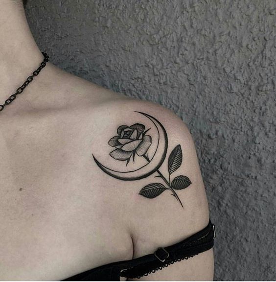 Tattoo of a rose and a month on the shoulder for women